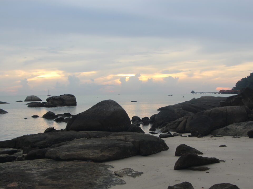 A serene scene of a beach abroad that shows a tranquil landscape to encourage calm thoughts in stressful times, helping professionals navigate career transitions.